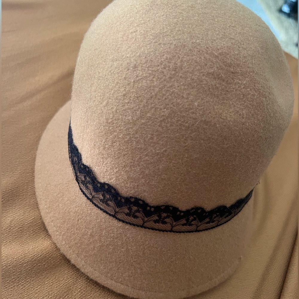 Camel color hat with black lace details.